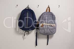 Schoolbags hanging on hook