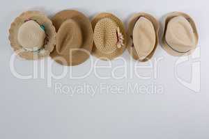Various straw hats hanging on hook