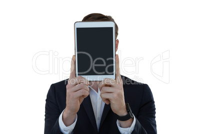Businessman hiding his face with digital tablet