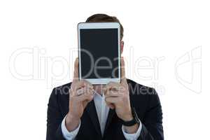 Businessman hiding his face with digital tablet