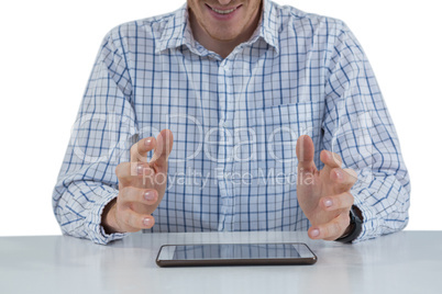 Male executive trying to hold digital tablet