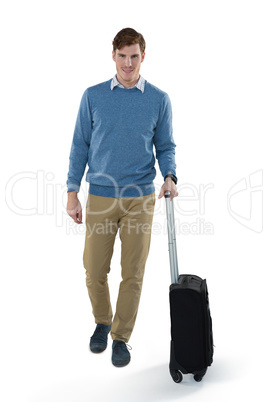 Male executive walking with luggage