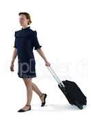 Female executive walking with suitcase