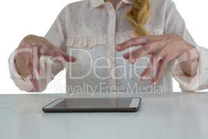 Female executive trying to hold digital tablet