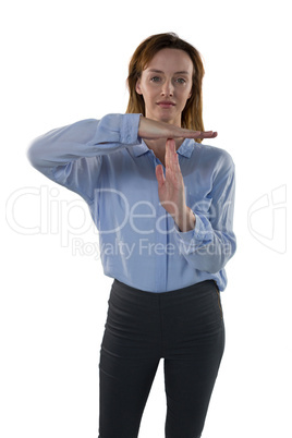 Female executive making time out sign