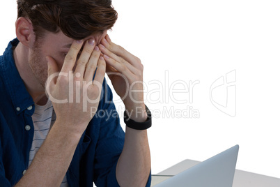 Worried male executive using laptop