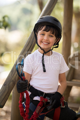 Portrait of cute boy holding carabiner