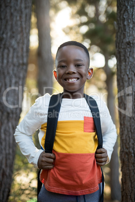 Close-up of cute boy standing with school bag