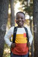 Close-up of cute boy standing with school bag
