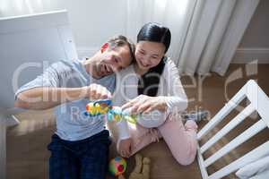 Happy couple playing with toys