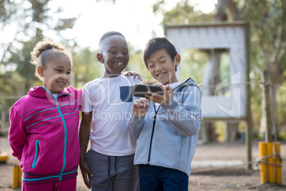 Happy kids using mobile phone