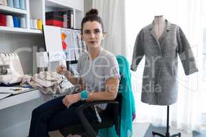 Fashion designer sitting on chair