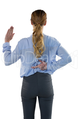 Female executive gesturing against white background