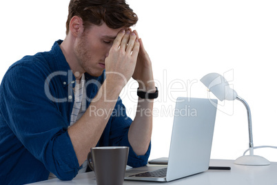 Worried male executive using laptop