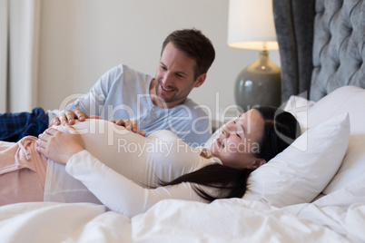Couple feeling the presence of baby in stomach