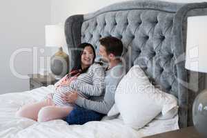 Man and pregnant woman interacting with each other