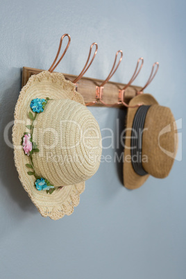 Straw hats hanging on hook