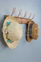 Straw hats hanging on hook