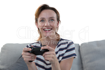 Woman playing video game against white background