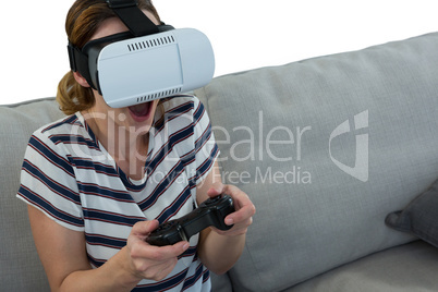 Woman playing video game with virtual reality headset