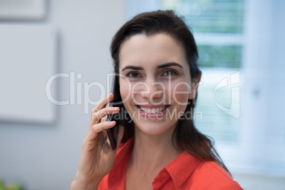 Woman talking on mobile phone at home