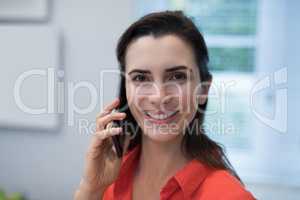 Woman talking on mobile phone at home