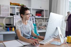Female designer working on personal computer