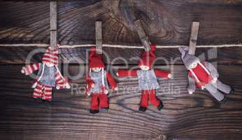 wooden dolls in winter clothes hang on a rope