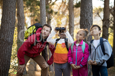 Teacher and kids exploring in park