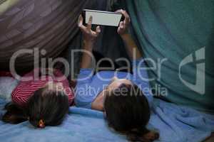 Mother and daughter using digital tablet