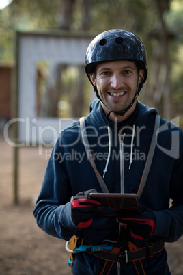 Instructor in protective workwear using digital tablet