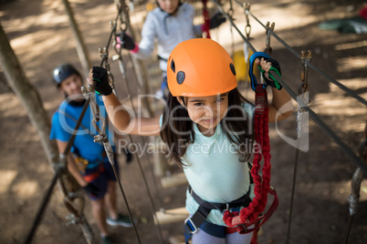 Cute girl crossing zip line