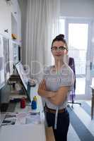 Portrait of female designer standing with arms crossed