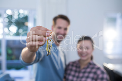 Couple showing a key of their new house