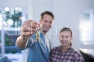 Couple showing a key of their new house