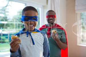 Father and son having muffin at home