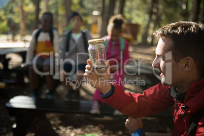 Teacher experimenting soil in park