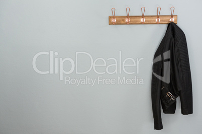 Leather jacket hanging on hook