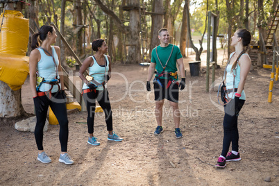 Coach and trainee interacting with each other in forest