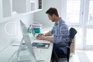 Man using laptop at desk