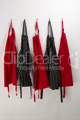 Various aprons hanging on hook