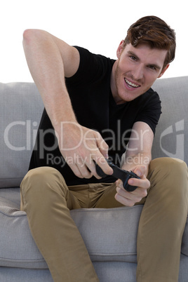 Man playing video game against white background