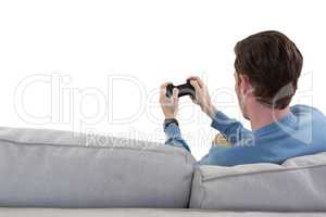 Man playing video game against white background