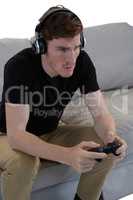 Man playing video game against white background