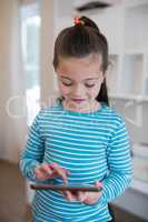 Girl using digital tablet in home