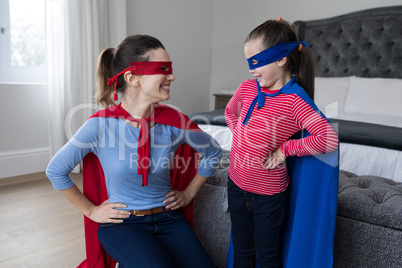 Mother and daughter pretending to be superhero
