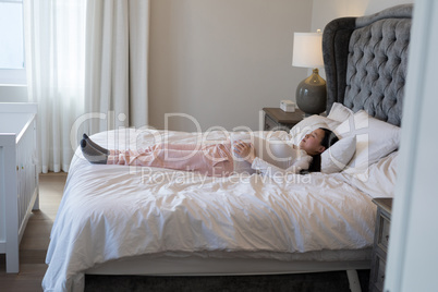 Pregnant woman relaxing in bedroom