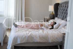 Pregnant woman relaxing in bedroom