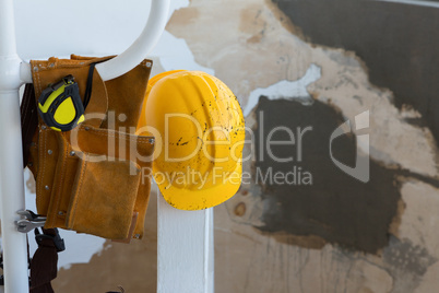 Tool belt, shoes and hard hat on a stand