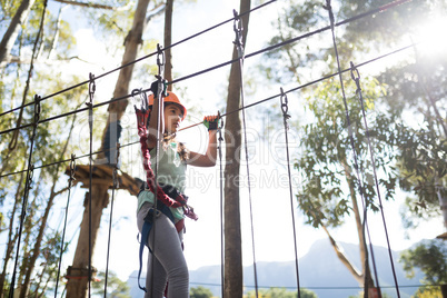 Determined girl crossing zip line